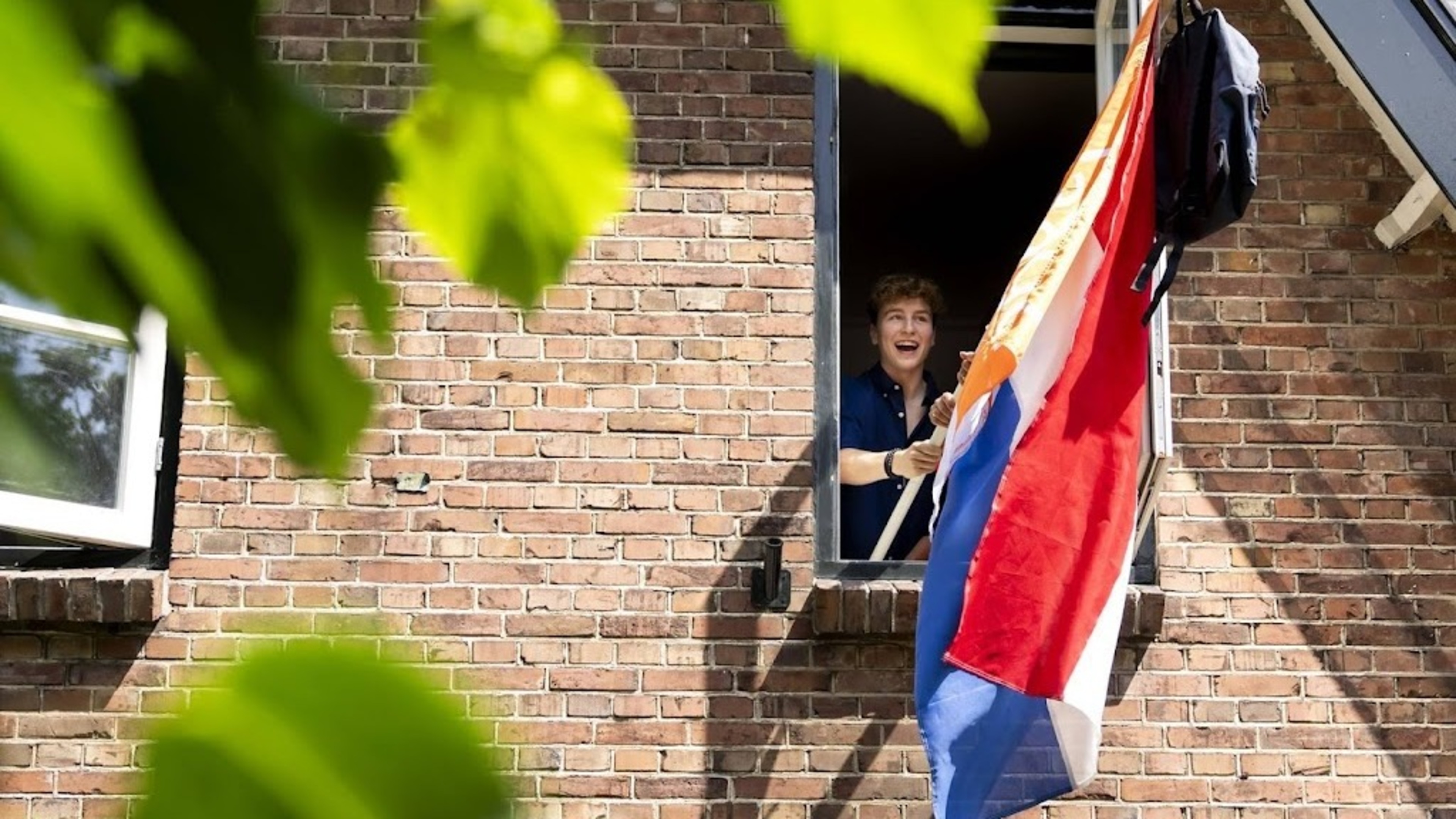 High school students find out if they passed and fly the flag