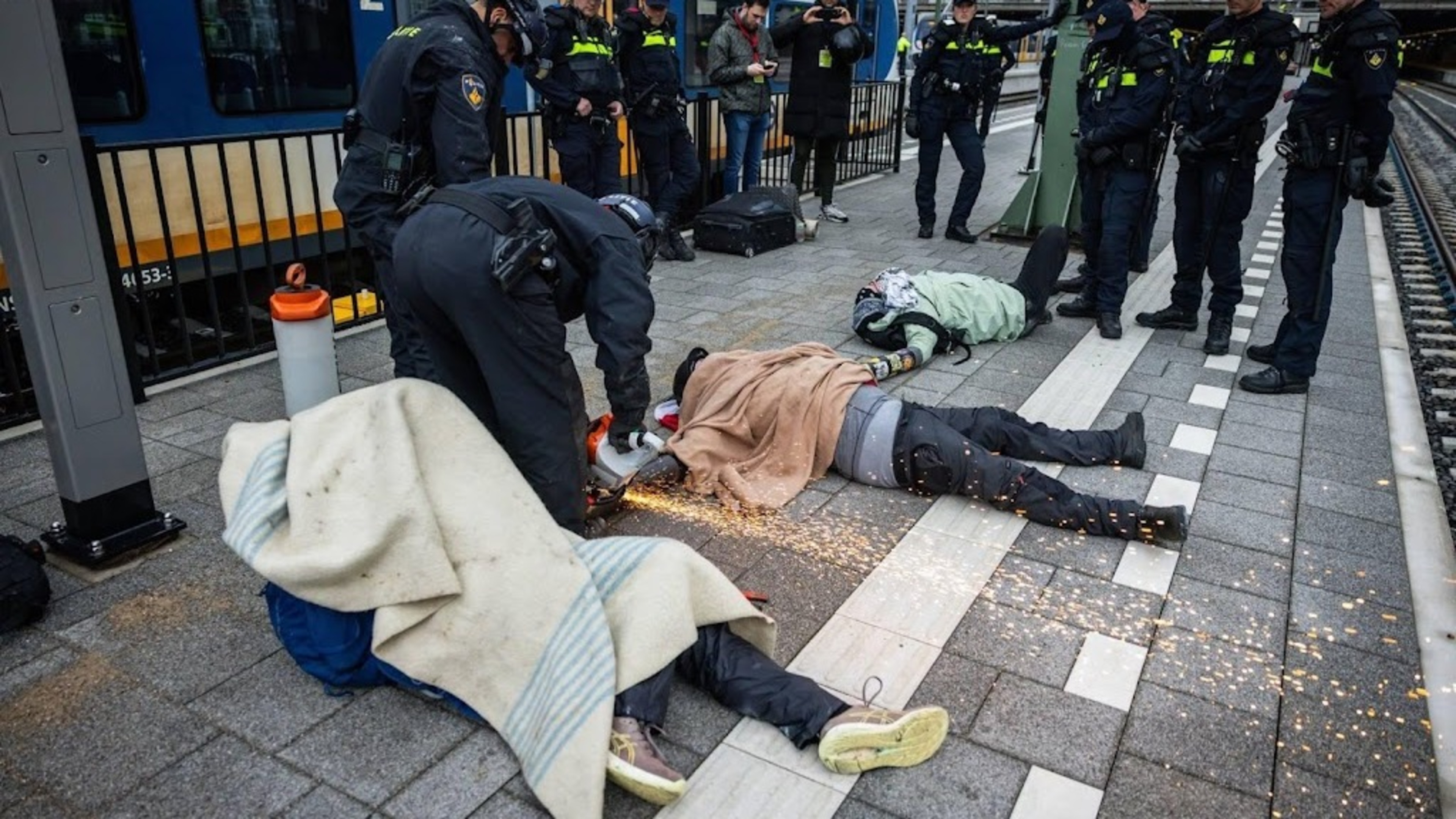 Police remove activists from tracks at The Hague Central