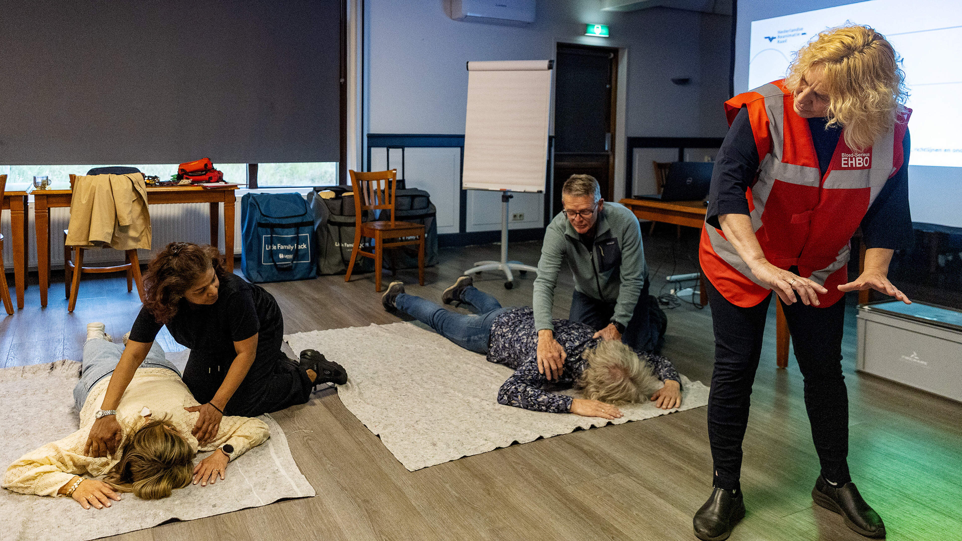 An evening of 'pumping hard, no complaining, and just doing it'. Trainer Carline teaches fellow villagers how to act during cardiac arrest.