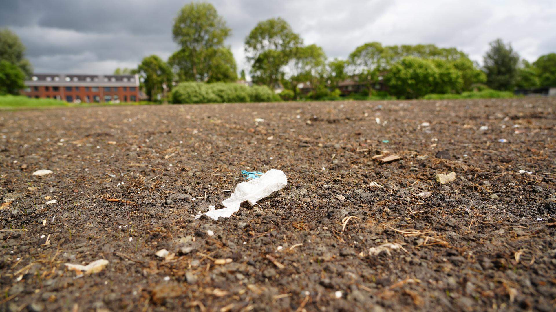 De grond waarmee het veld is opgehoogd bevat (plastic) afval.